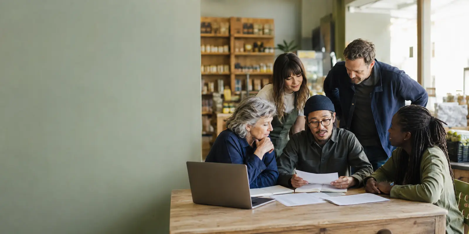 Members of a community cooperative reviewing board nominations and an election schedule